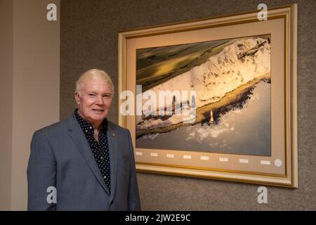 Il 617 Squadran Dambusters Association ambasciatore Bomber Command fund raising presidente Jim Dooley è in piedi con una fotografia firmata di una Lancaster Foto Stock