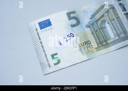 Banconota da cinque euro con prezzo da 2 euro a 5 cent. Attenzione selettiva all'etichetta. Inflazione in Europa, iperinflazione, svalutazione del concetto di moneta fiat. Foto Stock