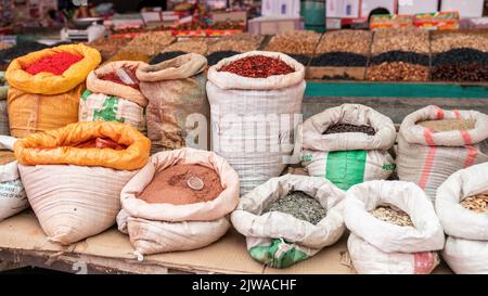 OSH, Kirghizistan - Maggio 2022: Borse di spezie colorate al bazar del mercato principale OSH Foto Stock