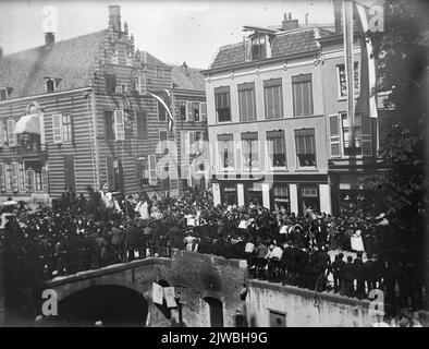 Immagine delle folle sulla Pausdam di Utrecht durante, presumibilmente, la parata della Maskerade in occasione del 270th° anniversario dell'Hogeschool, che rappresenta il tour trionfale dell'imperatore Gaius Julius Ceasar Germanicus Drusus a Roma; Sullo sfondo il Paushuize (Kromme Nieuwegracht 39) e sulla destra il Nieuwegracht.n.b. L'indirizzo Kromme Nieuwegracht 39 è stato cambiato in Kromme Nieuwegracht 49 nel 1930 o nel 1931. Foto Stock