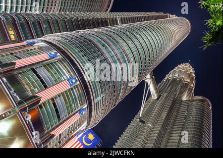 Paesaggio, immagine ravvicinata delle Torri Gemelle Petronas con la bandiera malese in primo piano, Kuala Lumpur, Malesia Foto Stock