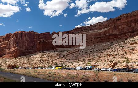 Moab, Utah - Una lunga fila di auto in attesa di entrare nel Parco Nazionale di Arches in un pomeriggio estivo. Il Servizio del Parco Nazionale sta sperimentando richiedendo Foto Stock