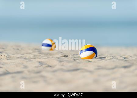 Beach volley palle sulla spiaggia di sabbia. Poster con tema sportivo orizzontale, biglietti d'auguri, intestazioni, sito Web e app Foto Stock