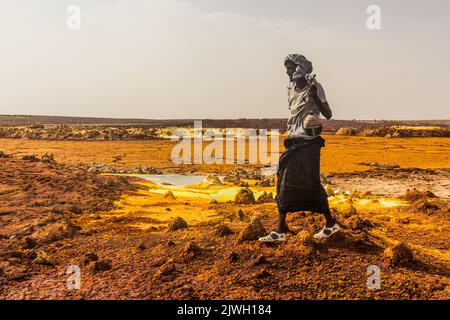 DANAKIL, ETIOPIA - 24 MARZO 2019: Guardia armata locale di Afar nel paesaggio vulcanico di Dalol nella depressione di Danakil, Etiopia. Foto Stock