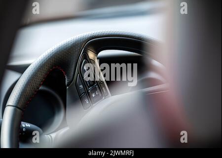 Auto con vista interna e moderno volante, cruscotto. Messa a fuoco selettiva. Profondità di campo bassa Foto Stock