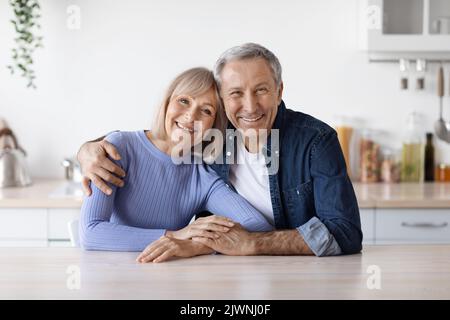 Ritratto di coppia anziana amorevole felice che si posa insieme in cucina Foto Stock
