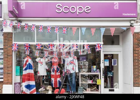 Le bandiere Bunting e Union riempiono la finestra di un negozio di Haslemere per celebrare il Platinum Jubilee della Regina. Foto Stock