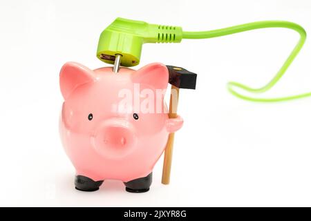 Cavo elettrico verde e piggy bank, concetto di risparmio utilizzando fonti di energia rinnovabili alternative, sfondo bianco Foto Stock