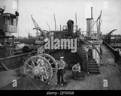 L'Old Royal Yacht è spogliato - già indossando un look desolato è il vecchio Royal Yacht Victoria e Albert che è stato spogliato delle sue attrezzature a Portsmouth Dockyard prima di essere rotto. Con la ruota che è stata utilizzata su quattro Royal Yachts è A.S. P. Revill, di Lichfield. Sul ponte a destra si trova P.O. V. CCX, di Portsmouth, mentre su gradini, da sinistra a destra si trovano: P.O.D. Granger di Chichester; O.S. J. James di Hereford, e A.B.D.M. Tago di Lansfield. I mobili più pregiati sono già stati trasferiti al nuovo Royal Yacht Britannia e a Buckingham Palace. Settembre Foto Stock