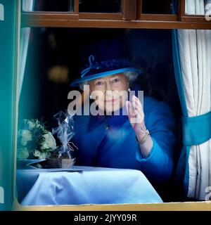 File foto datata 09/09/15 della Regina Elisabetta II, il giorno in cui divenne il più lungo monarca regnante della Gran Bretagna, sventolando da un finestrino della carrozza alla Stazione di Waverley di Edimburgo, dopo aver salito a bordo di un treno a vapore per inaugurare la nuova Scottish Borders Railway da £294 milioni di dollari. La Scozia è stata un luogo speciale per la Regina nel corso dei decenni, sia per le vacanze che per i doveri reali. Ha trascorso parte della sua luna di miele a Birkhall nella tenuta rurale Balmoral nell'Aberdeenshire e la tenuta era la sua residenza preferita in Scozia. Data di emissione: Giovedì 8 settembre 2022. Foto Stock