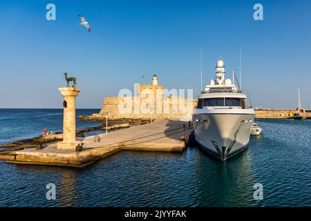 Porto di MANDRAKI con statua di cervi, dove si trovava il Colosso e forte di San Nicola. Rodi, Grecia. Statua di Hirschkuh al posto del Coloss Foto Stock