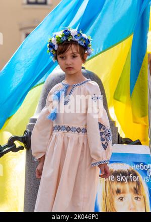 Cracovia, Polonia. 09th Set, 2022. Ragazza Ucraina in abito tradizionale e fiore headdress è visto contro bandiera Ucraina durante la dimostrazione. Gli ucraini e i loro sostenitori protestano contro una guerra russa di oltre sei mesi contro l'Ucraina nella piazza principale della città vecchia di Cracovia. I manifestanti vengono per le strade di Cracovia due volte al giorno, come dicono, ricordano il destino del popolo ucraino. Credit: SOPA Images Limited/Alamy Live News Foto Stock