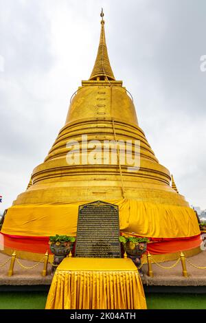 Tempio di Wat Saket con stupa dorata e statua d'angelo. Simbolo del buddismo nella città di Bangkok, Thailandia. Maestoso e simbolo religioso della cultura tailandese. Nuvola Foto Stock