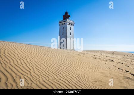 L'iconico faro Rubjerg Knude Fyr nelle dune della Danimarca settentrionale in una giornata estiva Foto Stock