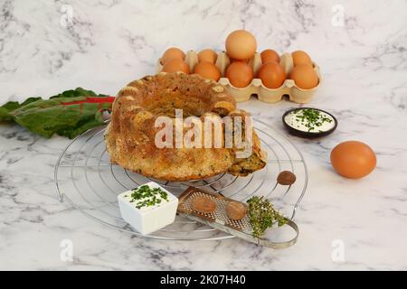 Cucina sveva, torta di bietole con salsa alle erbe, formaggio cagliato, pasticceria sostanziosa, torta salata, vegetariano, cottura, griglia di raffreddamento, griglia per torte, grattugia per noce moscata Foto Stock