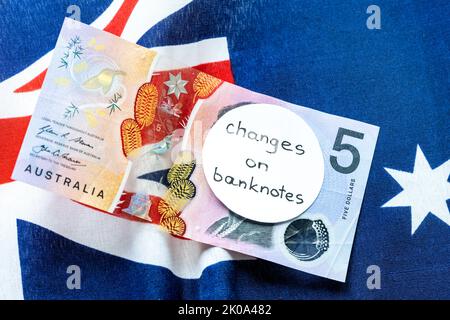 Cambio dell'immagine sulla banconota australiana in dollari, denaro giacente sulla bandiera australiana con l'iscrizione manuale: Cambio banconote, denaro ecc Foto Stock