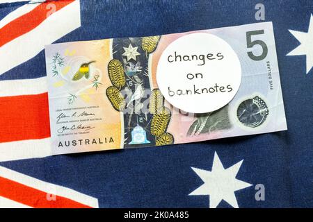 Cambio dell'immagine sulla banconota australiana in dollari, denaro giacente sulla bandiera australiana con l'iscrizione manuale: Cambio banconote, denaro ecc Foto Stock