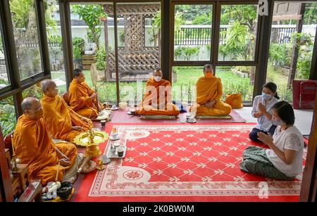 Bangkok, Thailandia. 09th Set, 2022. I devoti che offrono preghiere durante la cerimonia di benedizione. I monaci buddisti thailandesi eseguono una cerimonia di benedizione “Tam Boon” in un nuovo business aperto - Café 123 nel centro di Bangkok. Cinque monaci fanno il merito eseguendo canti ritmici e candele leggere che gocciolano cera in una ciotola di acqua Santa, portando buona fortuna all'istituzione. Credit: SOPA Images Limited/Alamy Live News Foto Stock