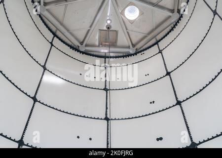 Immagine di un interno non descritto, all'interno, di un serbatoio di accumulo di acqua sfuso in acciaio nuovo e vuoto, in uno spazio ristretto. Foto Stock