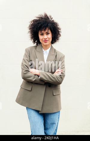 donna d'affari fiduciosa con le braccia incrociate sorride felice guardando la macchina fotografica, il concetto di imprenditore di successo e la gioventù Foto Stock
