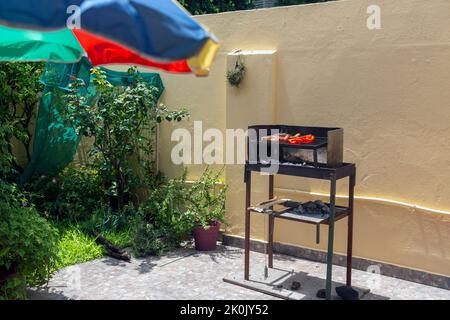 vista di un piccolo barbecue in casa nel cortile Foto Stock