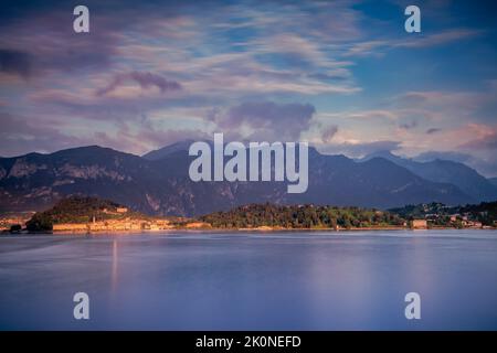 Montagne e skyline di Bellagio, vista dal lago di Como al tramonto, Italia settentrionale Foto Stock