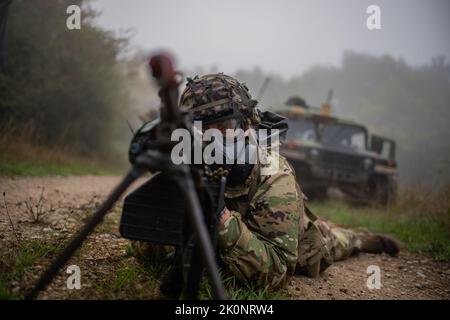 Un paracadutista dell'esercito degli Stati Uniti assegnato a 4th battaglione, 319th Airborne Field Artillery Regiment fornisce la sicurezza perimetrale con un attacco M249 durante un attacco chimico, biologico, radiologico e nucleare (CBRN) al Joint multinazionale Readiness Center di Hohenfels, Germania come parte dell'Exercise Saber Junction 22, 12 settembre 2022. Saber Junction 22 è un esercizio di rotazione multinazionale progettato per valutare la disponibilità della Brigata aerea 173rd dell'esercito statunitense ad eseguire operazioni terrestri unificate in un ambiente congiunto e combinato e per promuovere l'interoperabilità con più di 4.500 partecipanti del Foto Stock
