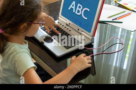 Apprendimento a distanza per i bambini. Sviluppo di computer per il bambino. Comunicazione virtuale. Foto Stock