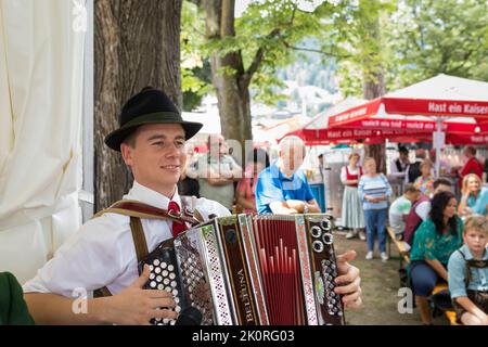 Musicista che suona musica folk in costume tirolese in una festa nel parco, Zell am See, Austria Foto Stock