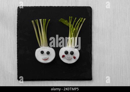 volti divertenti da blackberry e raddish, modo creativo sul piatto isolato Foto Stock