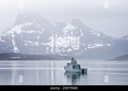 Nave danese di pattuglia della Marina HDMS Ejnar Mikkelsen circondata da montagne innevate nell'insenatura che conduce a Nuuk (Groenlandia) il 20 luglio 2022 Foto Stock