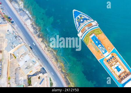 Nave da crociera ormeggiata accanto al mare turchese argine nella baia della città, vista dall'alto aerea Foto Stock