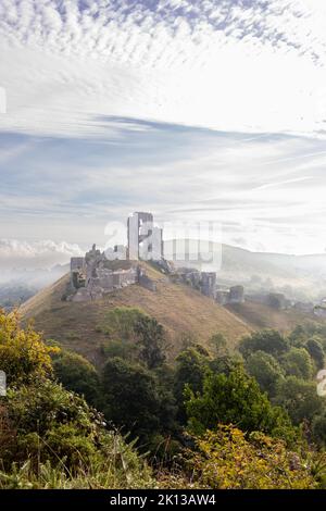 Vista del castello di Corfe nell'isola di Purbeck, Dorset, Inghilterra in una mattina misteriosa a settembre Foto Stock