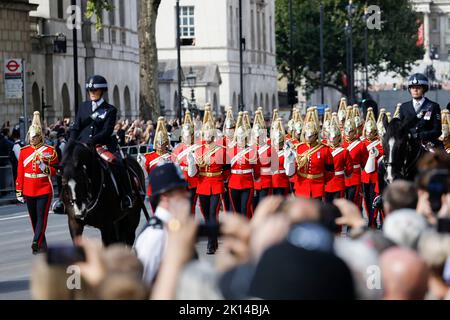 Soldati della Guardia di vita distaccati della Cavalleria domestica nella processione come la bara della regina Elisabetta II, drappeggiato nello Standard reale con la corona di Stato imperiale posta in cima, è portato lungo Whitehall su un carro trainato da cavalli della truppa reale Artillery Cavallo, Durante la processione cerimoniale da Buckingham Palace a Westminster Hall, Londra, dove si trova in stato prima del suo funerale di lunedì. Data immagine: Mercoledì 14 settembre 2022. Foto Stock