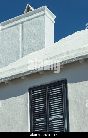 Bermuda architettura Beige House con Dark Shutters Street Lamp Post & Red Hibiscus Bush primo piano Foto Stock
