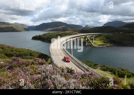 Auto che attraversa il ponte Kylesku sulla costa settentrionale 500 strada panoramica attraverso Highland, Scozia, Regno Unito Foto Stock