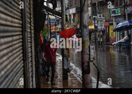 Srinagar, India. 17th Set, 2022. 17 settembre 2022, Srinagar, Jammu e Kashmir, India: La gente cammina lungo una strada durante una pioggia a Srinagar. Credit: ZUMA Press, Inc./Alamy Live News Foto Stock