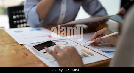 Persone aziendali che discutono con la pianificazione dei colleghi analizzando grafici e grafici dei dati dei documenti finanziari in Meeting e concetto di lavoro di squadra di successo Foto Stock