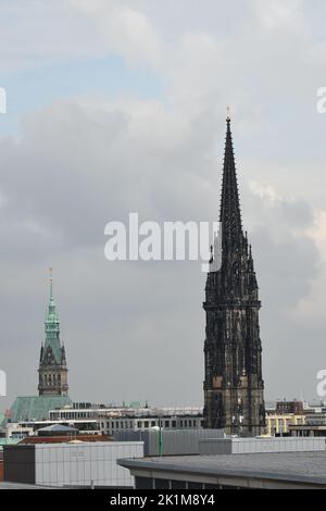 La vecchia torre della chiesa di San Nikolai sotto il cielo nuvoloso di Amburgo Foto Stock