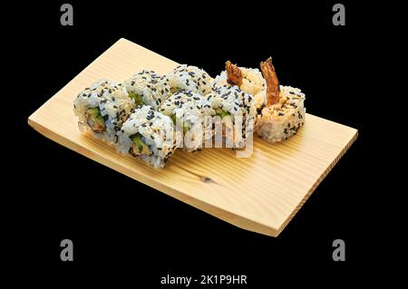 Delicious Spice EBI Maki roll su un piedistallo di legno su uno sfondo nero isolato Foto Stock