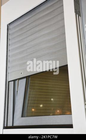 Primo piano su persiane avvolgibili casa finestre di protezione con zanzariera schermo. Foto Stock