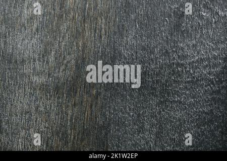 La texture di legno compensato grigio. La consistenza della superficie liscia del compensato grigio. Vista dall'alto del vecchio sfondo in compensato. Foto Stock