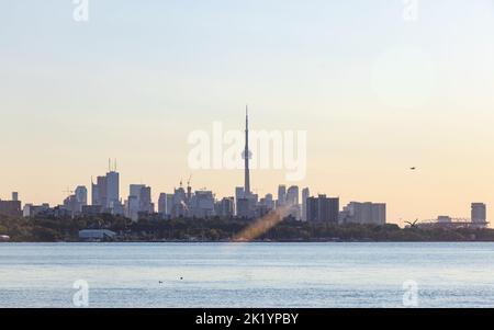 Lo skyline di Toronto, con la CN Tower al centro, è visibile dall'altra parte della riva del lago Ontario al mattino presto. Foto Stock