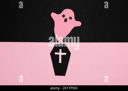 bara nera su una parte rosa dello sfondo, fantasma rosa su una parte nera dello sfondo, fantasma che esce dalla bara, concin creativo di halloween Foto Stock