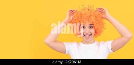 felice ragazza divertente egoistico con un look di fantasia indossando capelli arancio parrucca e principessa corona, vincitore. Donna isolato volto ritratto, banner con spazio copia. Foto Stock