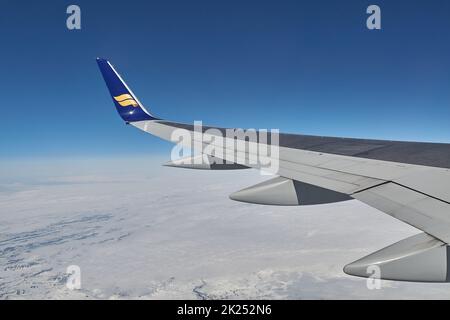 Reykjavik, Islanda - circa 2018: Volo Icelandair punta di alare visto sopra la copertura nuvolosa su un volo, guardando fuori dalla finestra Foto Stock