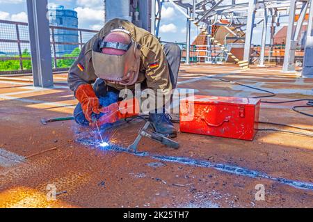 Saldatore al lavoro nel sito industriale di Neuenkirchen Foto Stock