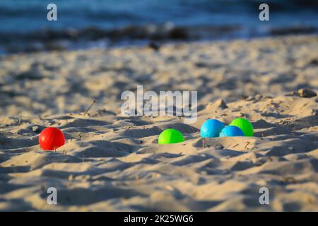 Palline di bocce colorate giacenti sulla spiaggia. Scena di giocare bocce. Foto Stock