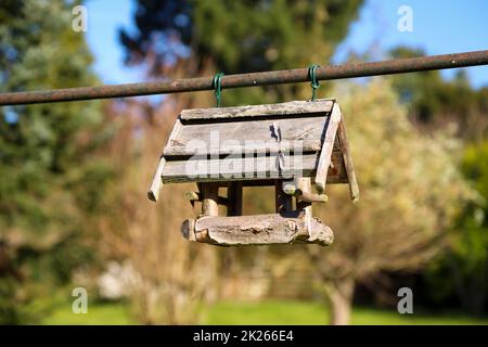 Una birdhouse di legno fissata ad un palo di metallo. Foto Stock