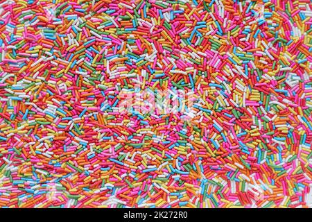Un sacco di sfondo di granuli di zucchero dai colori vivaci utilizzato per la condimenti di dessert, cupcake e gelato in Top View è uno sfondo colorato adatto f Foto Stock